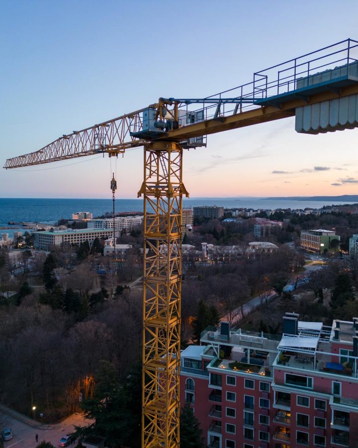 Busy Construction Site and Construction Equipment at night. Aerial top view